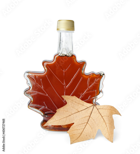 Bottle of sweet maple syrup and leaf isolated on white background