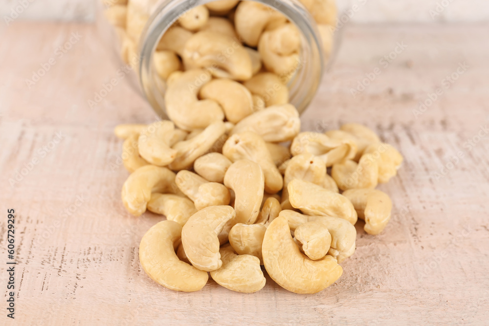 Heap of tasty cashew nuts on light background, closeup Heap of tasty cashew nuts on light background, closeup