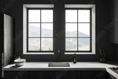 Dark kitchen interior with kitchenware  sink and panoramic window