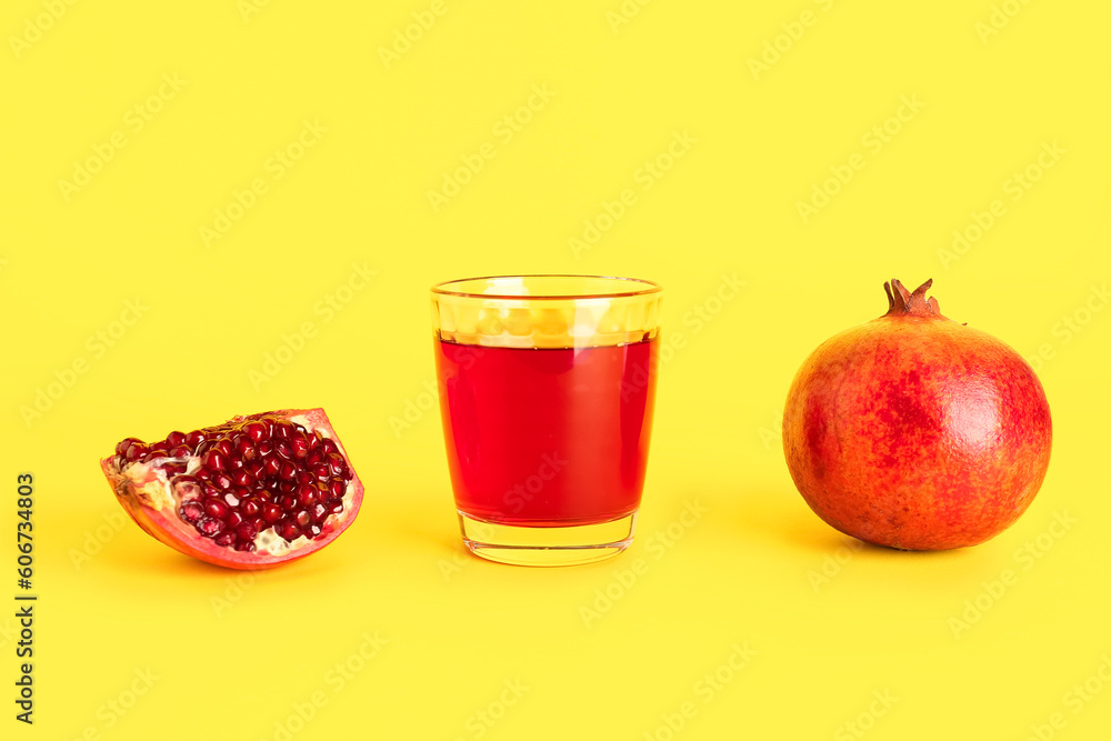 Glass of fresh pomegranate juice on yellow background Glass of fresh pomegranate juice on yellow background