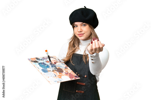 Young artist girl holding a palette over isolated chroma key background inviting to come with hand. Happy that you came