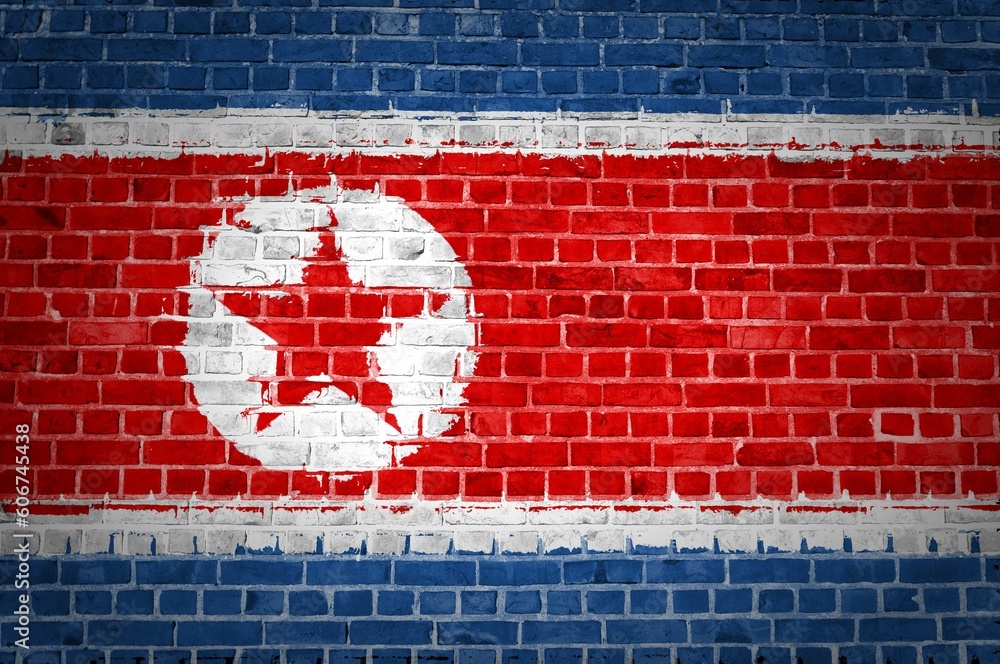 Shot of the North Korea flag painted on a brick wall in an urban location Shot of the North Korea flag painted on a brick wall in an urban location