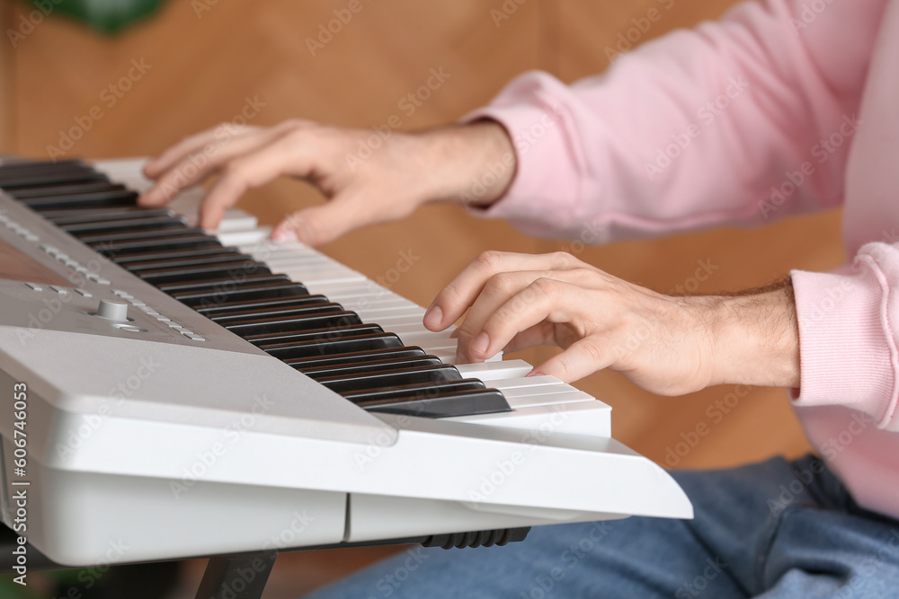 Obraz premium Male musician playing synthesizer at home, closeup