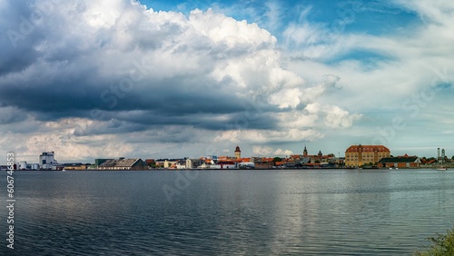 Seaside view to the old town under big white clouds, Nykobing Falster, Denmark