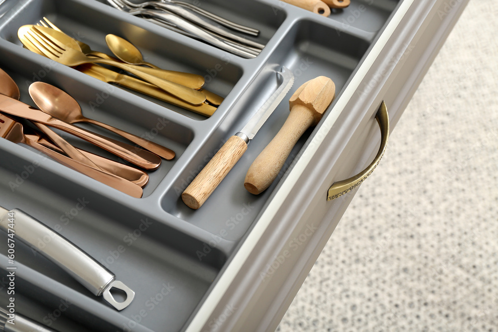 Open kitchen drawer with different cutlery Open kitchen drawer with different cutlery
