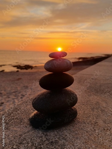 Photography Stack of rocks on top of each other on the beach at sunset