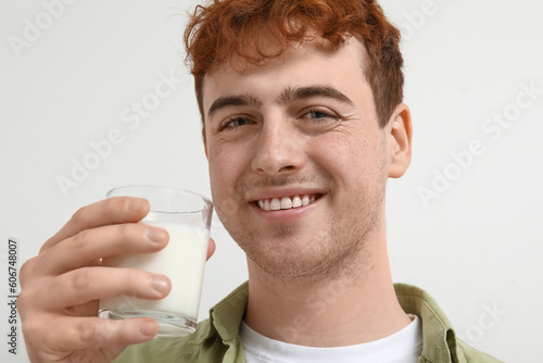 Smiling young man holding g...