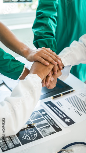 Stack of hands of International doctor team meeting hospital medical staff.