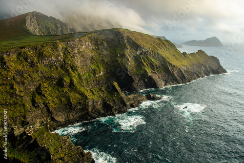 Photo of beautiful cliffs, mountains and dark sea in Ireland