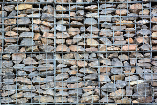Mesh fence filled with stones