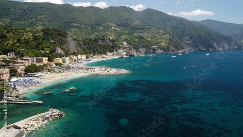 Aerial drone shot of a blue sea in the town of Monterosso al Mare, La Spezia, Italy
