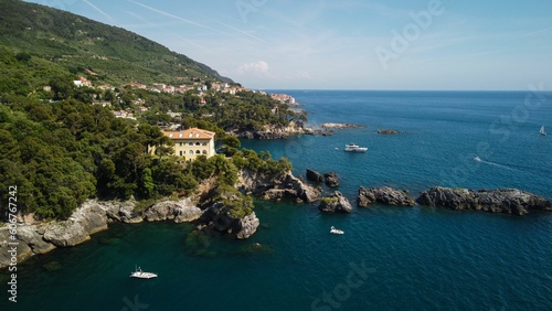 Fototapeta Naklejka Na Ścianę i Meble -  Aerial drone shot of a blue sea in the town of Monterosso al Mare, La Spezia, Italy