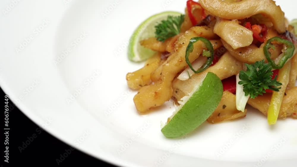 Spinning salad featuring lime, garnish and bell pepper on a white plate. Spinning salad featuring lime, garnish and bell pepper on a white plate.