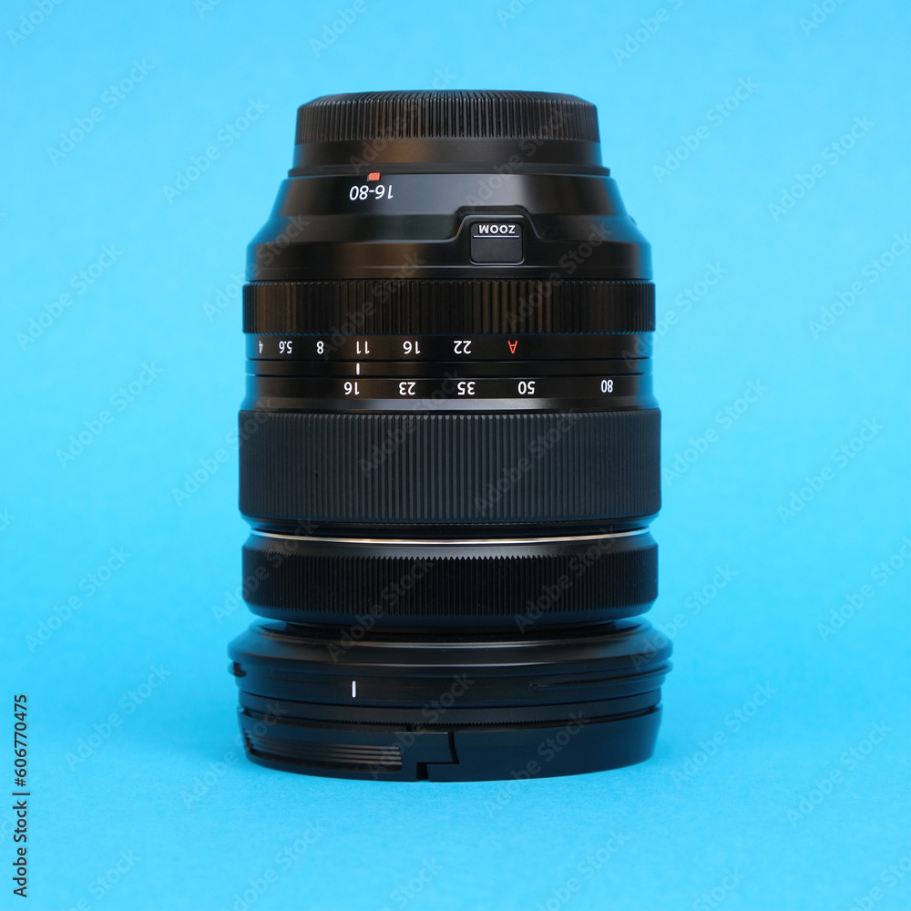 Fotografie typical zoom lens isolated on turquoise background