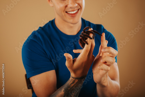 Close up of man playing with his tarantula