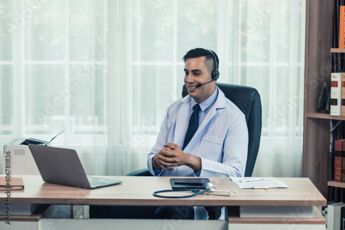 Physician conducts online, distant consultations via video call. Taking medical histories, dealing with patient's concerns, answering queries. Creating a treatment plan and prescribing medications.