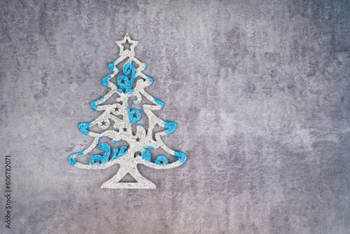 A Christmas tree for decoration on dark wall with empty space.