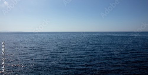 Calm deep sea, blue sky background texture. Empty space, Greece Cyclades island advertise template. © Rawf8