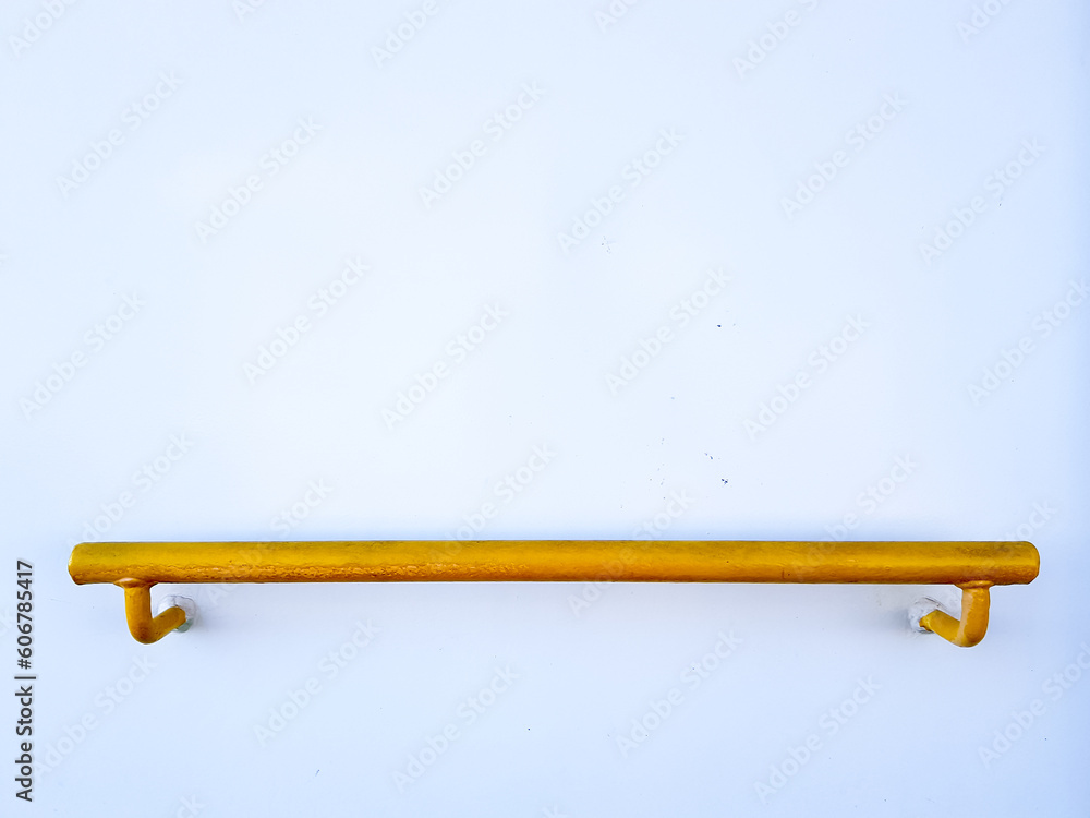 Yellow bar installed on white wall