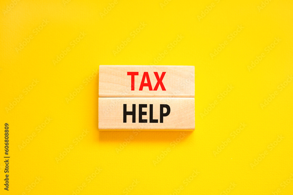 Tax help symbol. Concept words Tax help on wooden blocks on a beautiful yellow table yellow background. Business, support and tax help concept. Copy space. Tax help symbol. Concept words Tax help on wooden blocks on a beautiful yellow table yellow background. Business, support and tax help concept. Copy space.