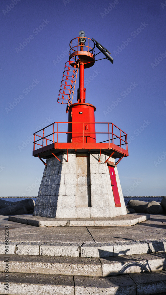 Small red lighthouse in Italy