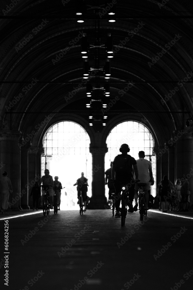 silhouettes of people walking in the tunnel