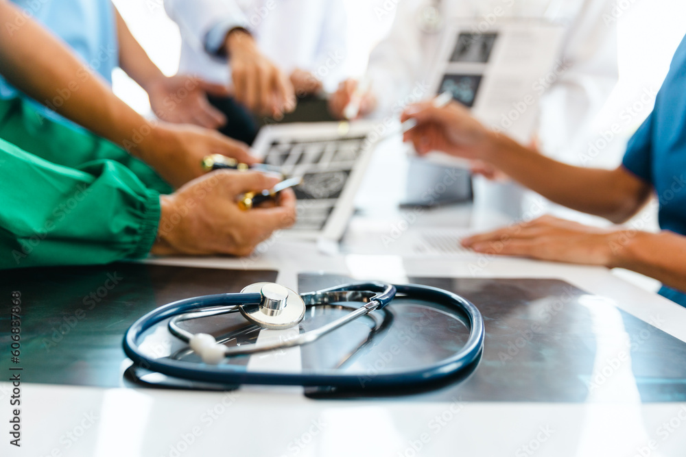 A team of young doctors discuss CT scan results in the clinic. Show patient results at the modern advanced diagnostic center. medical and health concept A team of young doctors discuss CT scan results in the clinic. Show patient results at the modern advanced diagnostic center. medical and health concept