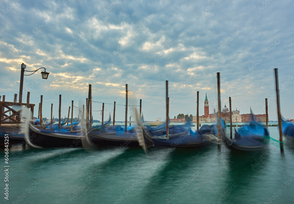 Gondolas at the St. Marks square in Venice, before a dramatic sunrise