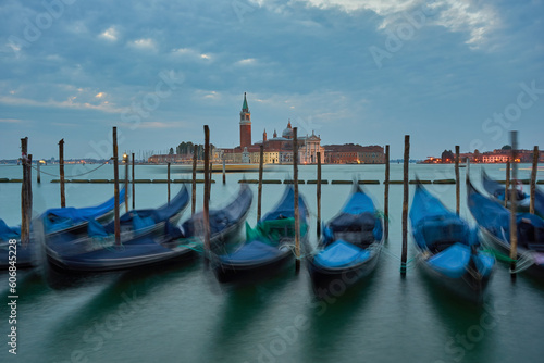 The most popular and romantic place in Venice. Gondolas moored at St. Mark's Square with the Church of San Giorgio di Maggiore in the background at sunset dawn, Venice.
