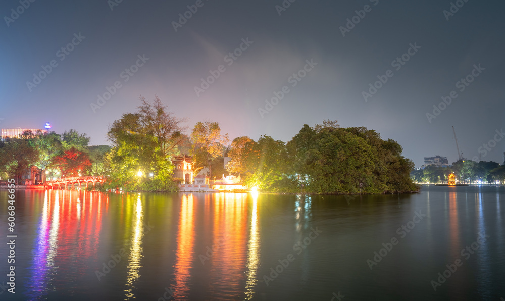Night view of The Huc Red Bridge and Turtle Tower in the center of Hoan Kiem Lake, Ha Noi, Vietnam. Famous destination of Vietnam