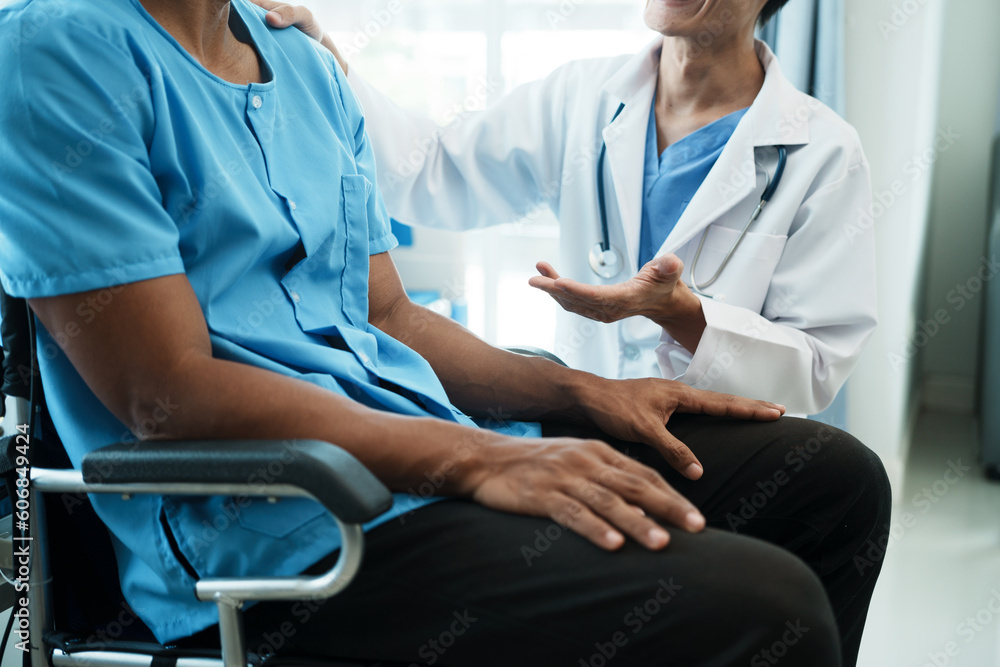 Friendly Male Doctor Talks to Male Patient. doctor with chart attending sick man in hospital ward. Friendly Male Doctor Talks to Male Patient. doctor with chart attending sick man in hospital ward.
