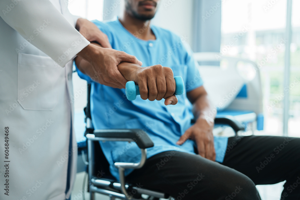 Doctor examining his patient arm in medical office while the patient sitting on hospital bed. Doctor examining his patient arm in medical office while the patient sitting on hospital bed.
