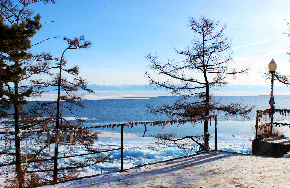 Winter Lake Baikal landscape with ice and buryat traditional ribbons