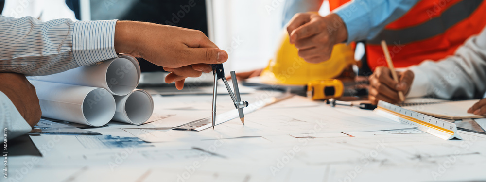 Architect or engineer working on building blueprint, contractor ...