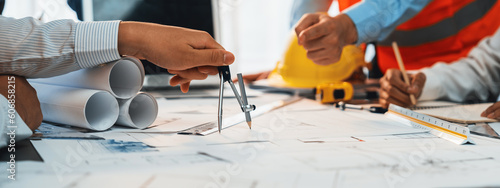 Architect or engineer working on building blueprint, contractor designing and drawing blueprint layout with tool for construction project. Civil engineer and architecture design concept. Insight