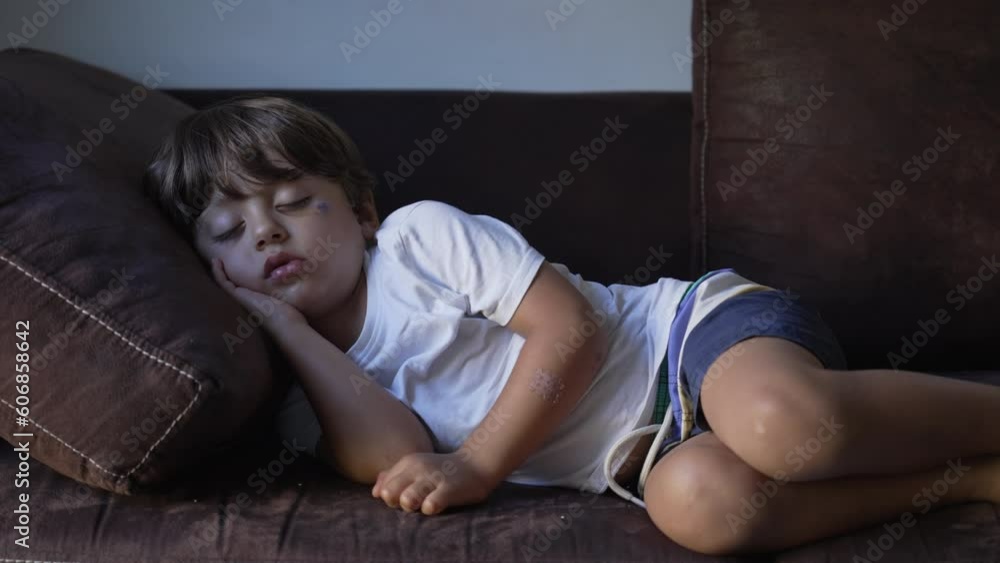 One child asleep during afternoon nap on couch. adorable little boy napping and resting. Relaxed kid with eyes closed One child asleep during afternoon nap on couch. adorable little boy napping and resting. Relaxed kid with eyes closed