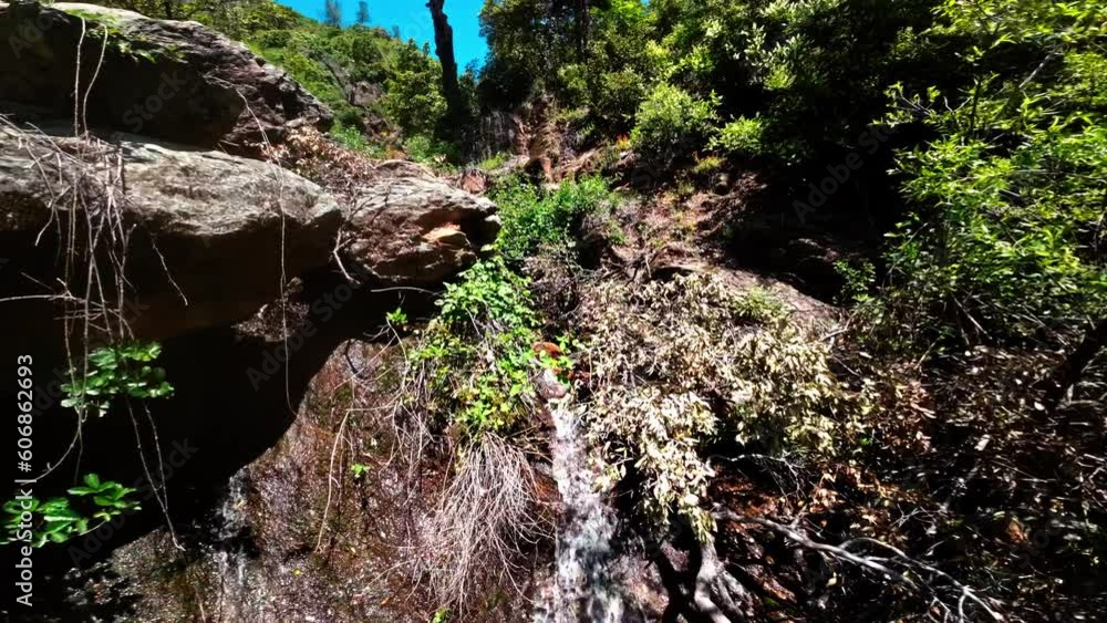 waterfall in the forest. following a creek with DJI FPV avata aerial view drone waterfall in the forest. following a creek with DJI FPV avata aerial view drone