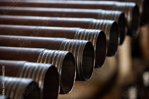 Oil drill pipes in graphite grease closeup. Low depth-of-field.