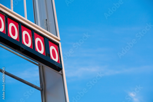 Abandoned gas station sign indicating zero.