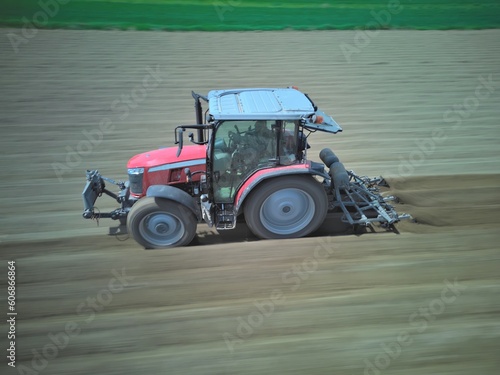 traktor orający pole . Zdjęcie z rozmyciem ruchu. widok z boku
