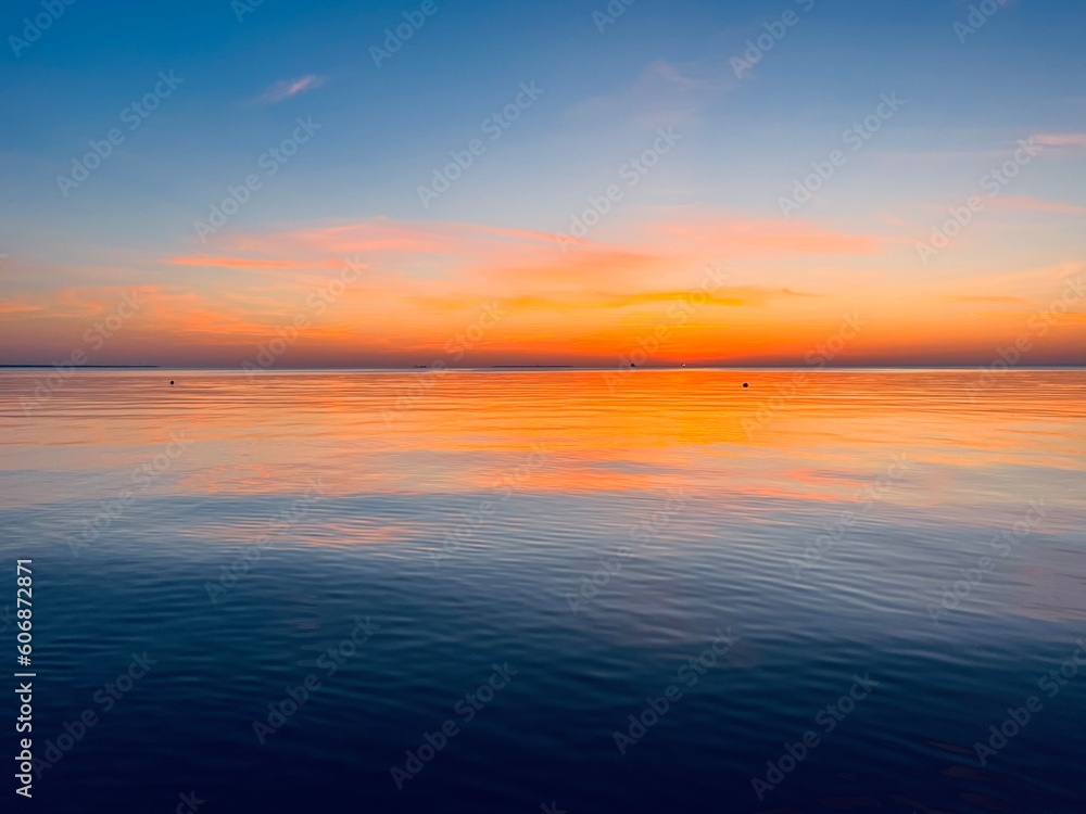 Orange sky after the sunset at the sea, evening sea horizon 