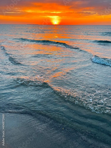 Fantastic orange sunset at the sea, natural colors of the sunset sky and sea water