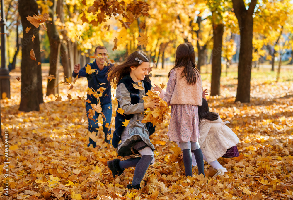 portrait of a large family with children in an autumn city park, happy people playing together and throwing yellow leaves, beautiful nature, bright sunny day portrait of a large family with children in an autumn city park, happy people playing together and throwing yellow leaves, beautiful nature, bright sunny day
