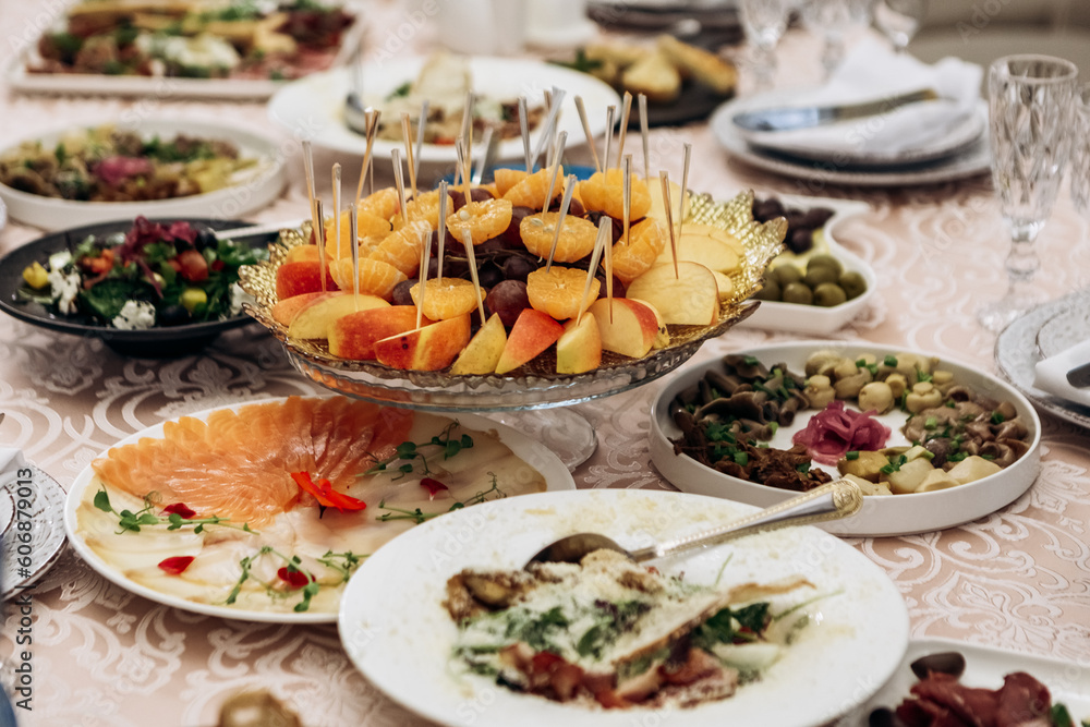 Banquet hall table set for event party wedding. Decorated interior in restaurant with snacks, salads, glasses, alcohol, fruits
Banquet hall table set for event party wedding. Decorated interior in restaurant with snacks, salads, glasses, alcohol, fruits