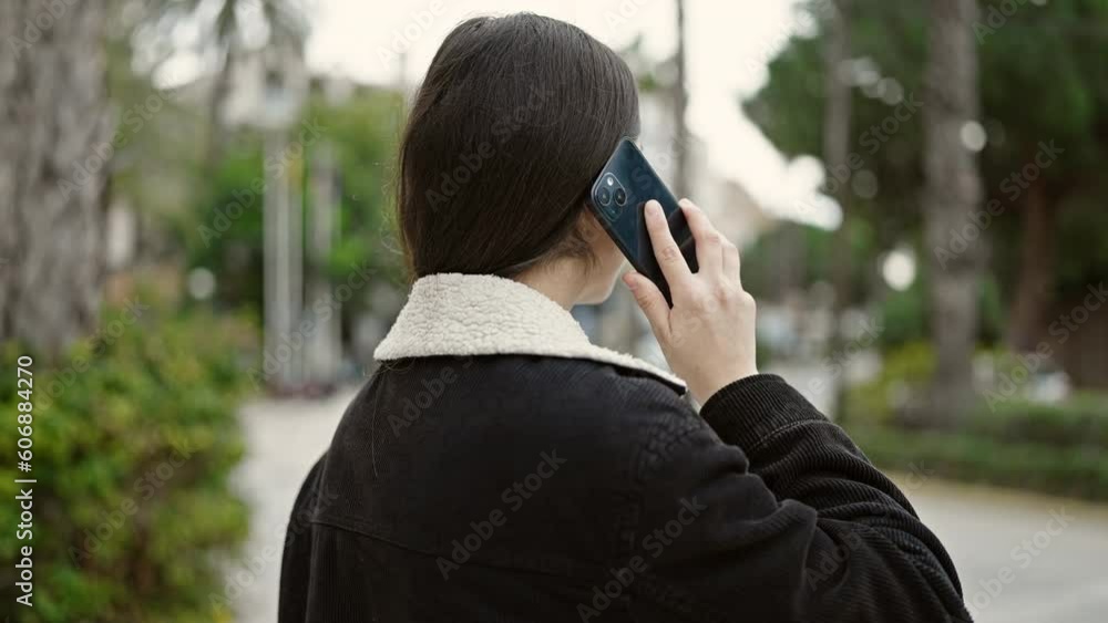 Young beautiful hispanic woman talking on smartphone at park Young beautiful hispanic woman talking on smartphone at park