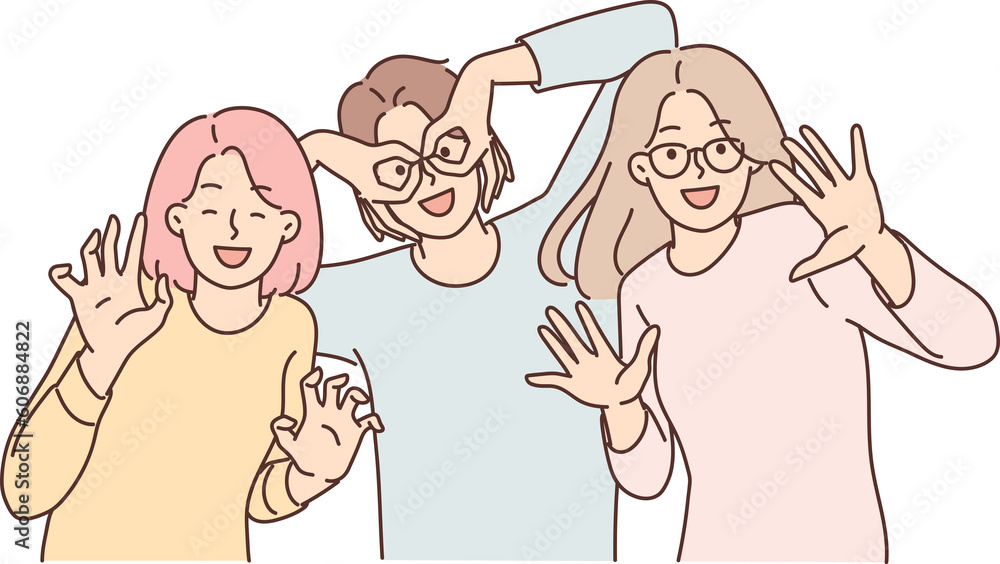Happy girls of friend have fun making funny faces and putting fingers to faces instead of glasses Happy girls of friend have fun making funny faces and putting fingers to faces instead of glasses
