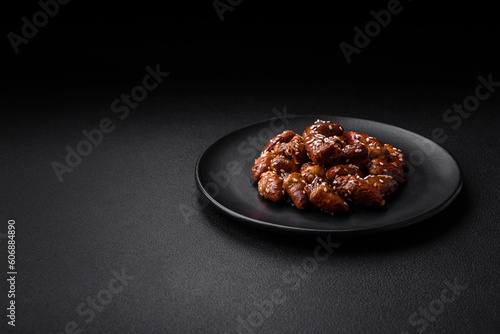 Chicken hearts fried in soy sauce with salt and spices in a plate