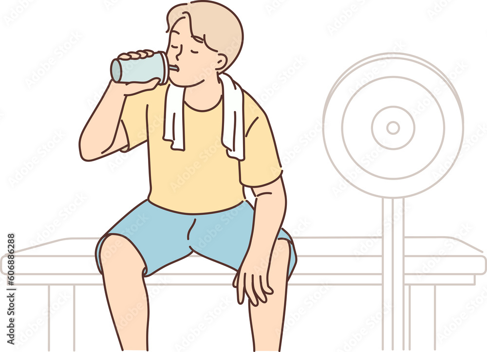 Φωτογραφία Man is in fitness club and drinks protein shake from shaker to restore carbohydr