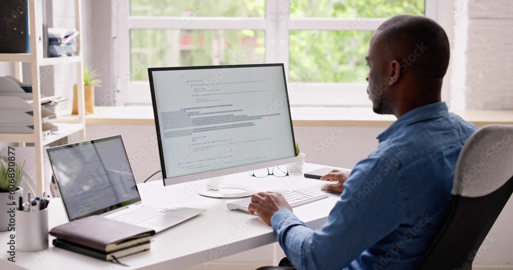 Computer Programmer Writing Program Code On Computer Computer Programmer Writing Program Code On Computer