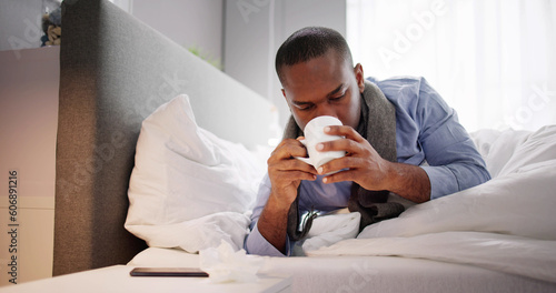 Fototapeta Sick Man Sitting On Bed Holding Cup